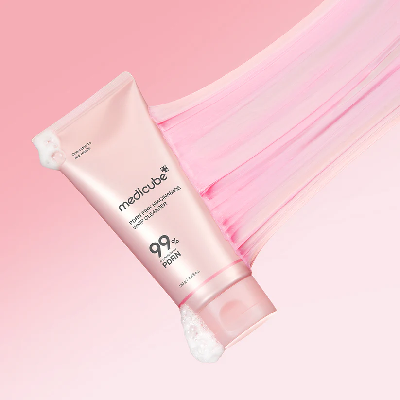 Pink skincare product with 'medicube' branding on a pink background