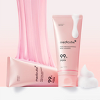 Two pink tubes of Medicube skincare product with whipped cream on a light pink background